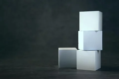 Three white cardboard boxes on a dark background. Mock up, Stockfoto's