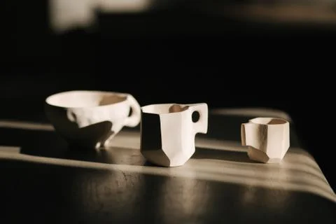 Three white ceramic cup different sizes on the table Stock-Fotos