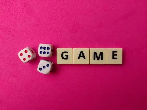 Three white dice showing different numbers are placed next to letter tiles .. Stock Photos
