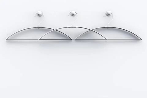 Three white empty hangers on a light wall. Foto stock