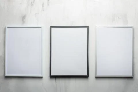 Three white frames on the wall background. The concept of design and font ins Stock Photos