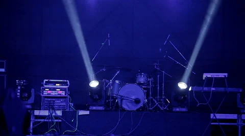 Three white spotlights, crossing each other. On the background of the drum set. Stock Footage 61216973