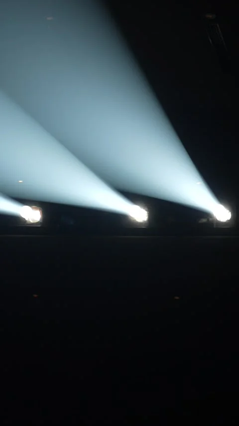 Three white stage spotlights with diagonal beams Vidéo 345740351