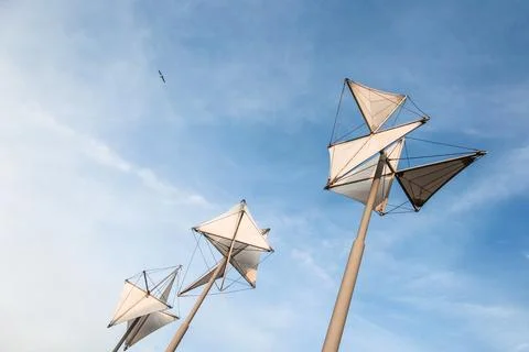 Three white structures with triangular shapes are standing tall in the sky .. Stock Photos