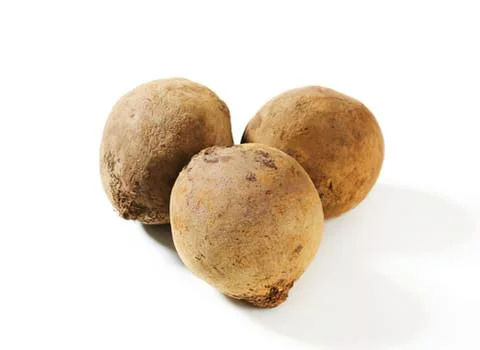 Three whole brown potatoes on surface Stock Photos