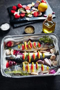 Three whole raw mackerel in a baking pan Stock Photos