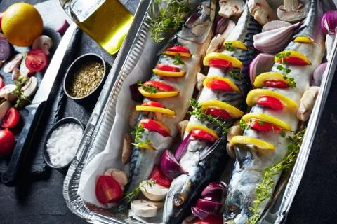 Three whole raw mackerel in a baking pan, top view Stock Photos