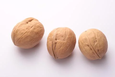 Three whole walnuts, isolated on white background Stock Photos