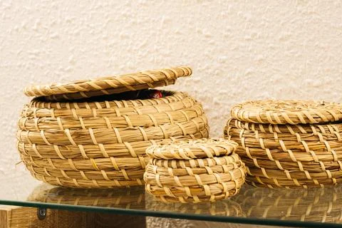 Three wicker baskets on a glass surface Stock Photos