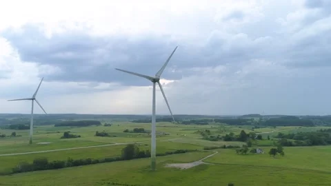 Three wind power turbines. Rainy cloudy sky. Aerial drone footage Stock Footage 133001239