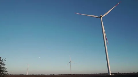 Three wind turbines are operating at full capacity around the clock in the field Video stock 158986975