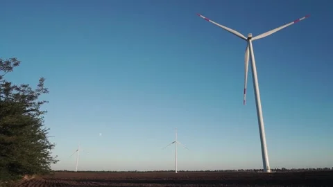 Three wind turbines are operating at full capacity around the clock in the field Video stock 159102894