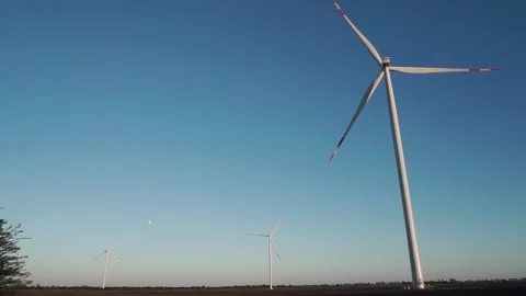 Three wind turbines are operating at full capacity around the clock in the field Video stock 159156791
