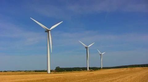 Three wind turbines in a small wind farm on a stubble field on Møn in Denmark 스톡 동영상 44434499