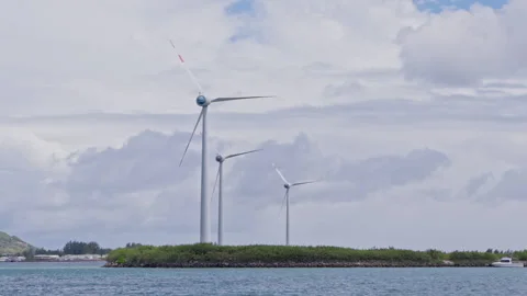 Three wind turbines standing still against a backdrop of clouds Stock Footage 236554075