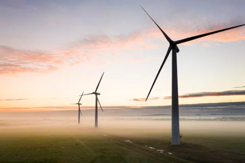Three wind turbines at sunrise Stock Photos