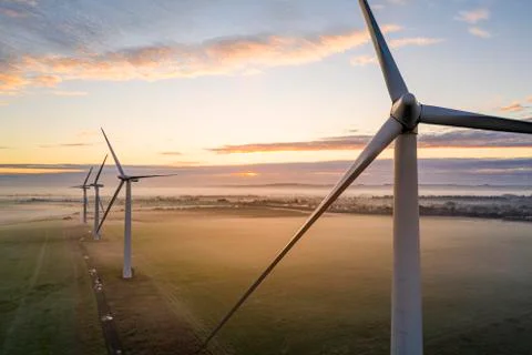 Three wind turbines at sunrise Stock Photos