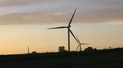 Three Wind Turbines at Sunset Stock Footage 7745840