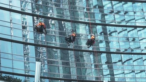 Three Window Cleaners Working on High Video stock 88600574