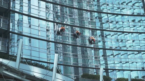Three Window Washers Working on High Video stock 88600412