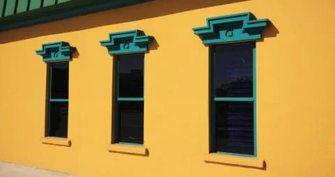 Three window on yellow wall Foto stock