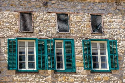 Three windows on facade of house Stock Photos