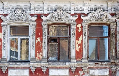 Three windows, a fragment of the facade of an ancient building Stock Photos