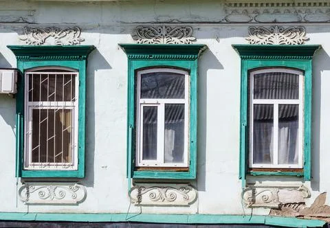 Three windows. Fragment of the facade of the old building Fotos de archivo