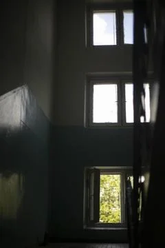 Three windows inside building. Interior of entrance. It's dark inside house. Stock Photos