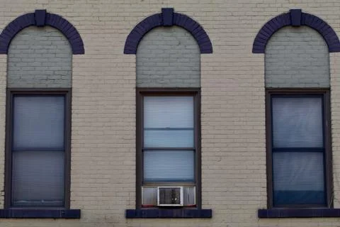 Three windows from a nineteenth century brick building Stock Photos