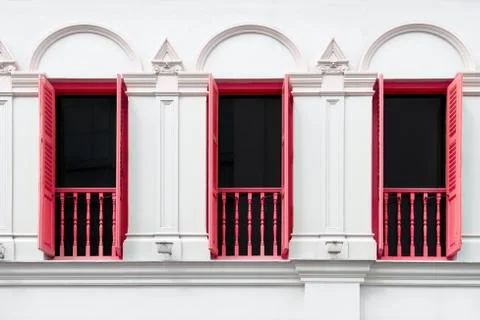 Three windows with red open shutters Stock Photos