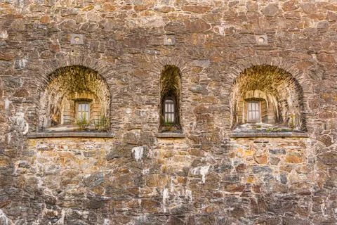 Three windows in a thick castle wall Stock Photos