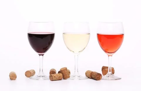 Three wine glasses and corks. Stock Photos