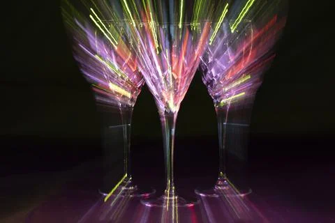Three wine glasses zoom burst purple light Stock Photos
