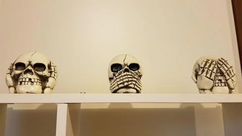 Three wise monkeys. Deaf, blind and mute monkey. In the shape of skulls. Sku Stock Photos