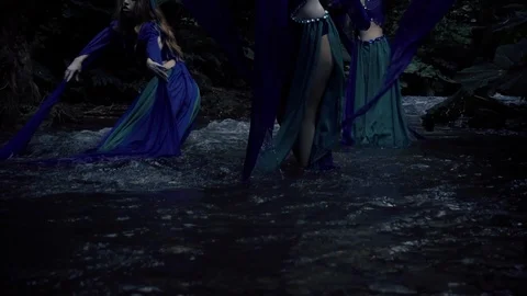 Three witches are dancing on the river Stock Footage 94535049