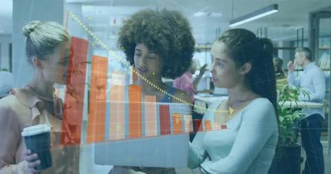 Three women analyzing data on laptop in office with translucent chart overlays, Stock Photos