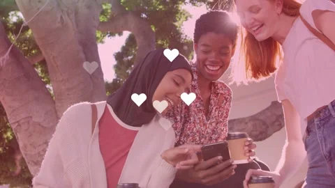 Three women bench mid scrolling phone left tapping causing hearts growing lens 動画素材 334694158
