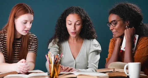 Three women of different ethnicities studying together Stock Footage 134463282