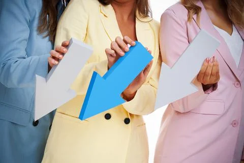 Three women in pastel suits posing with arrows over white background Stock Photos