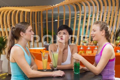 Three Women Talking in Sport Cafe after Training Stock Photos