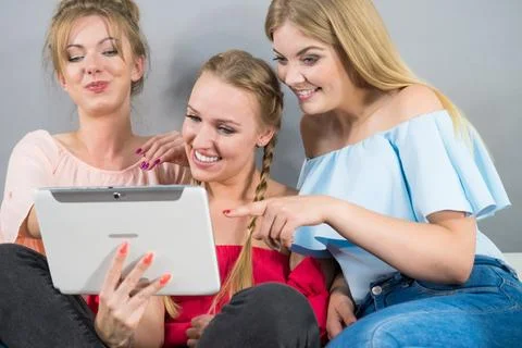 Three women using tablet Stock Photos