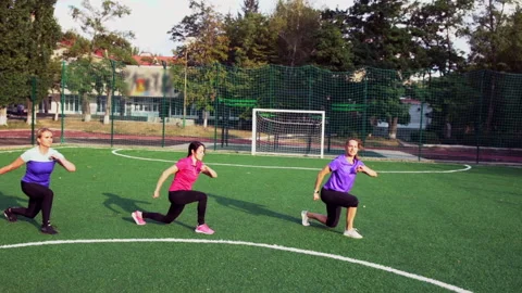 Three women working out doing lunge exercises Stock Footage 139808729