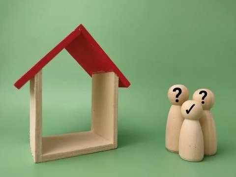 Three wooden figures with question or check marks stand beside an empty woo.. Stock Photos