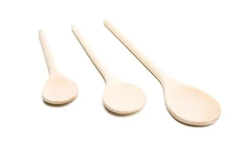 Three wooden spoons of different sizes on white background Stock Photos