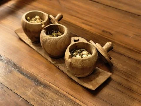 Three wooden tea jars opened to show loose jasmine tea Stock Photos