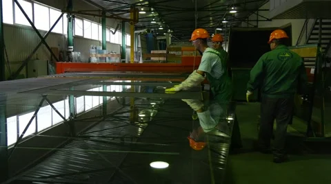 Three Workers are Taking Off the Pieces of Glass After Cutting by Robot, Stock Footage 52874408