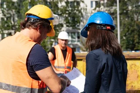 Three workers on construction site 스톡 사진