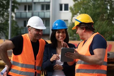 Three workers on construction site 스톡 사진
