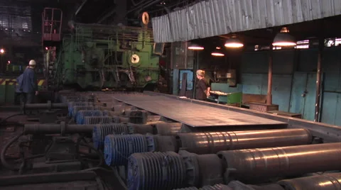 Three Workers Men And Senior Aged Woman Are Sanding at Metal Rolling Machine Stock Footage 53502131
